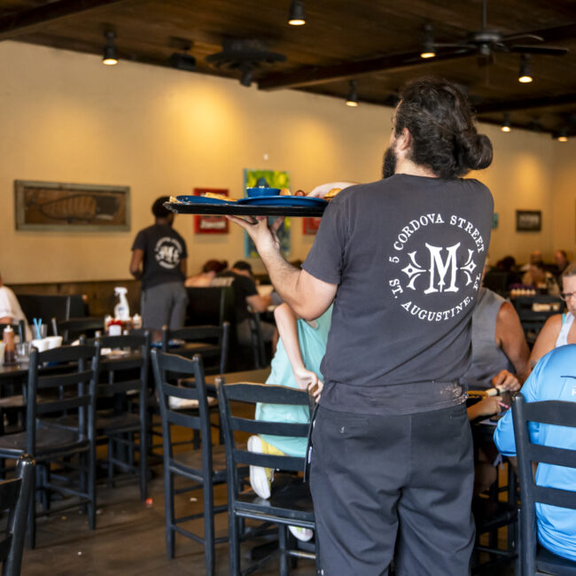 mojo old city server serving a group of people st augustine, fl